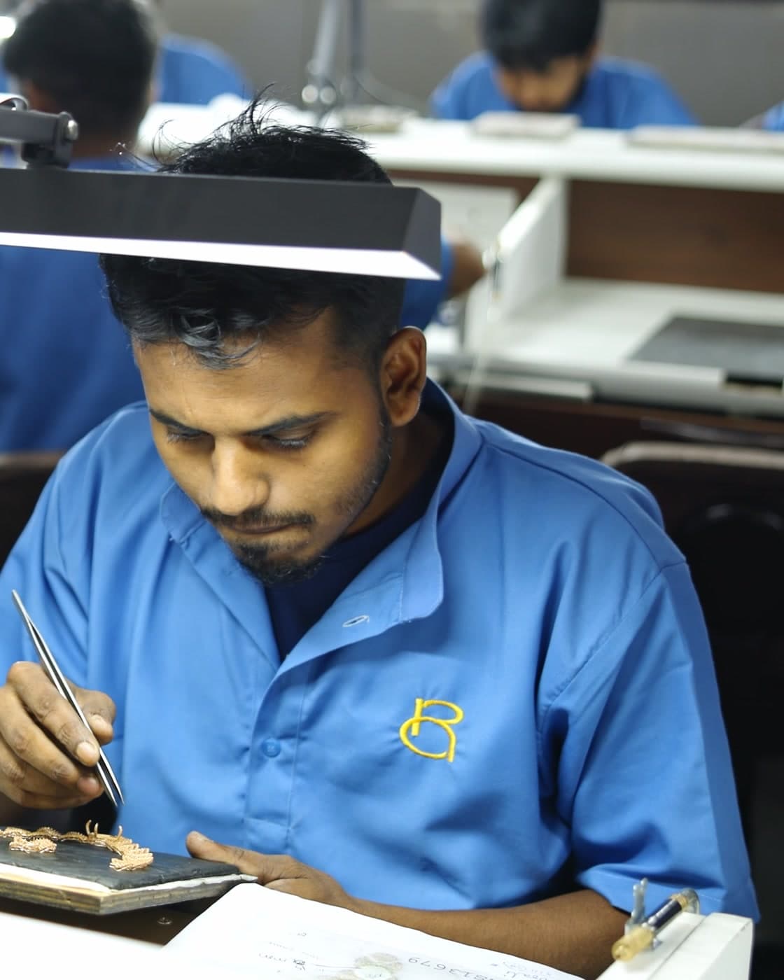 An artisan working at his bench in the Kolhapur facility