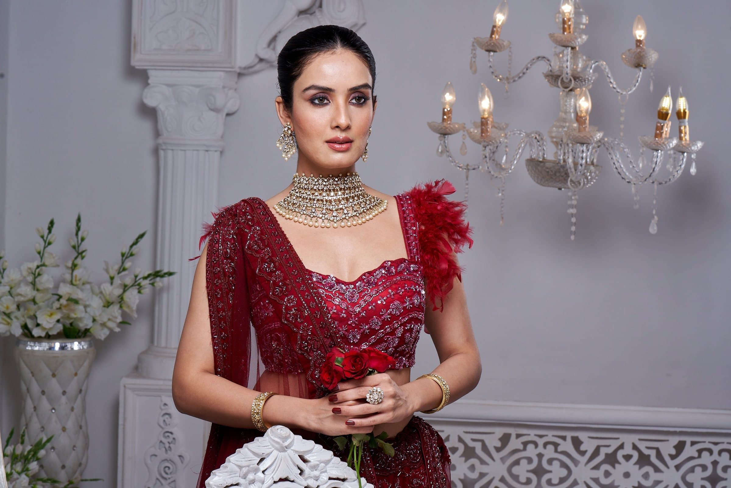 A model in a red lehenga wearing Polki jewellery from the Maharani collection